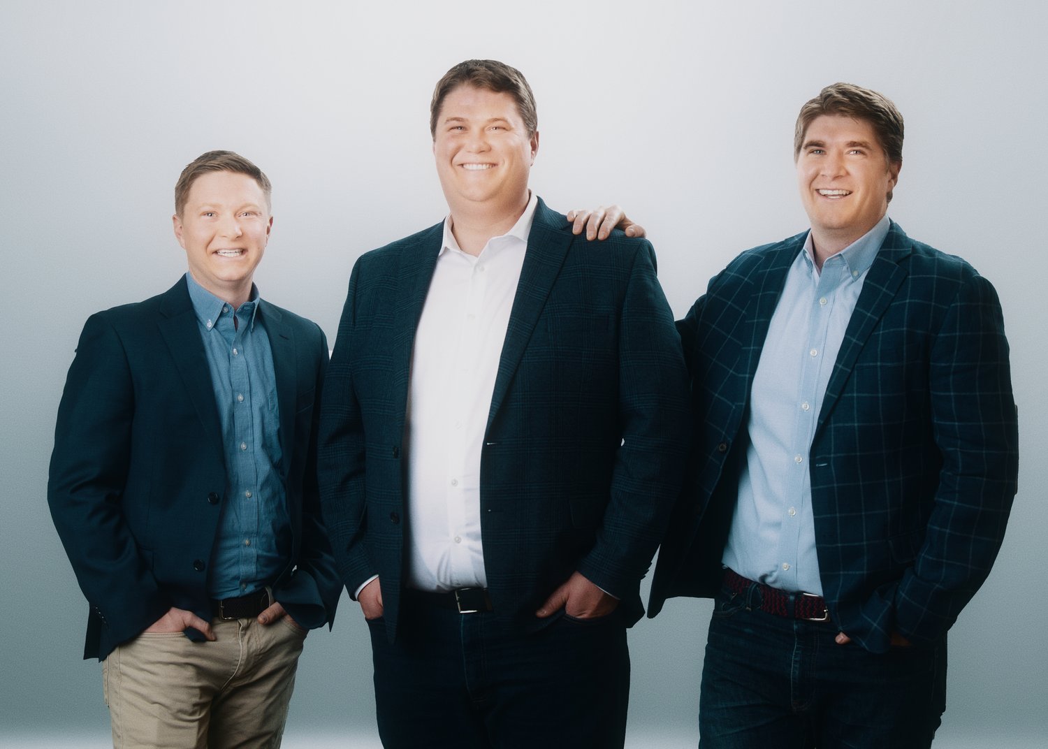 The three Team Haugen principals — Logan Haugen at center with Spencer Haugen and Hayden Haugen — in a formal portrait.